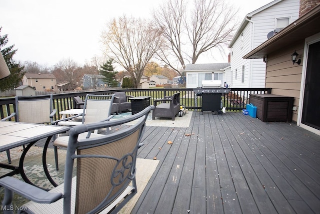 wooden terrace featuring a grill