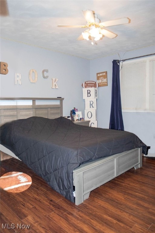 bedroom with ceiling fan and dark hardwood / wood-style floors