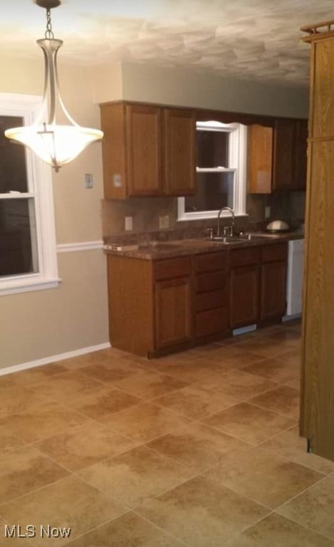 kitchen with decorative light fixtures and sink