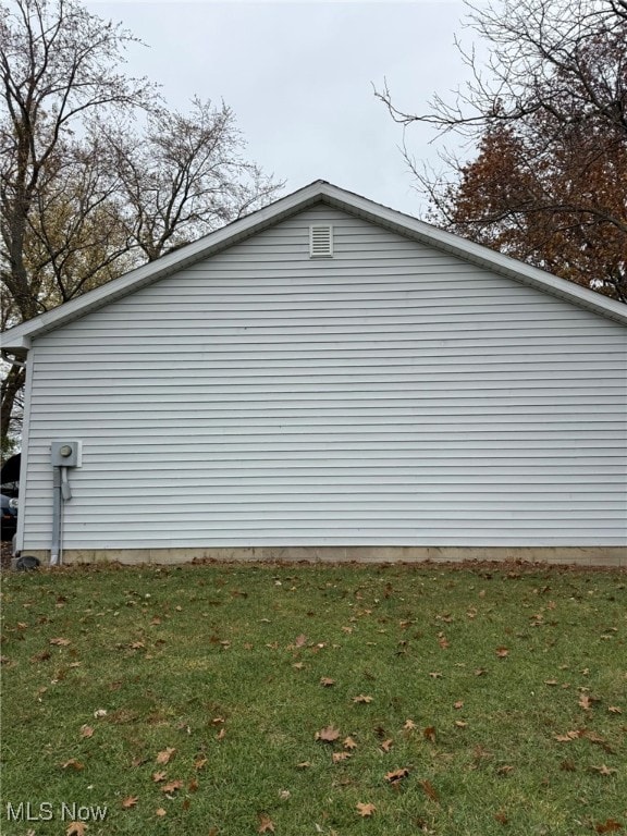 view of property exterior featuring a lawn