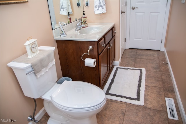 bathroom with tile patterned floors, vanity, and toilet