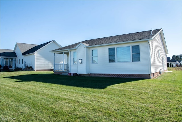 rear view of house with a lawn