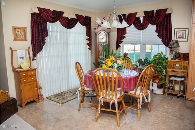 dining room with tile patterned floors and a notable chandelier