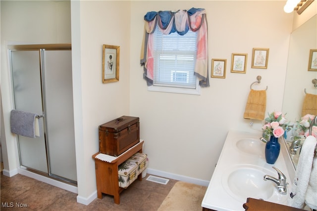 bathroom with tile patterned flooring, vanity, and walk in shower