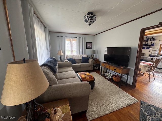 living room with crown molding and hardwood / wood-style flooring