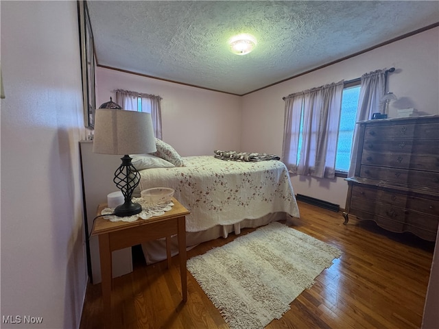 bedroom featuring wood-type flooring and a textured ceiling