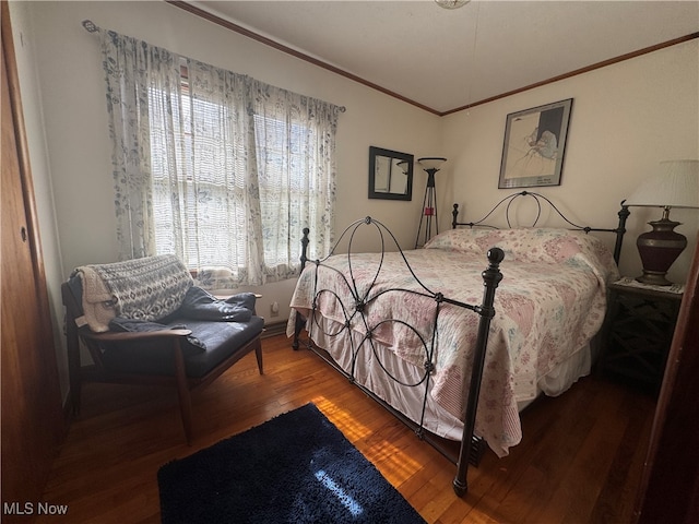 bedroom with hardwood / wood-style flooring and ornamental molding