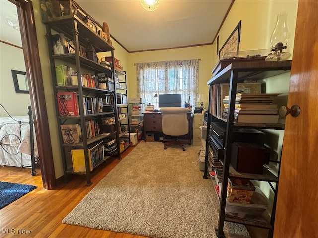 home office featuring hardwood / wood-style floors and crown molding