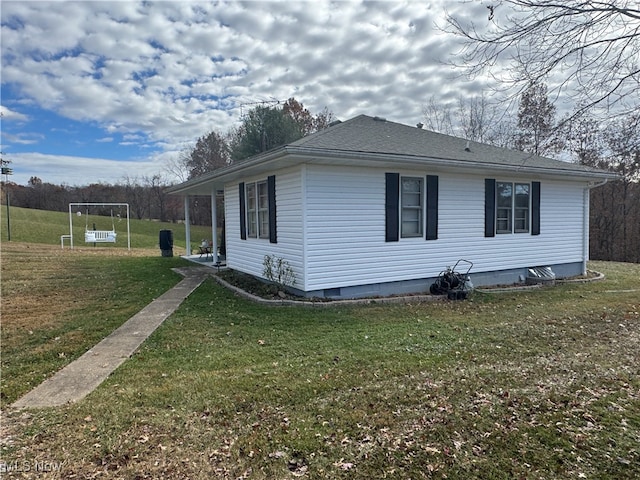 view of property exterior with a yard