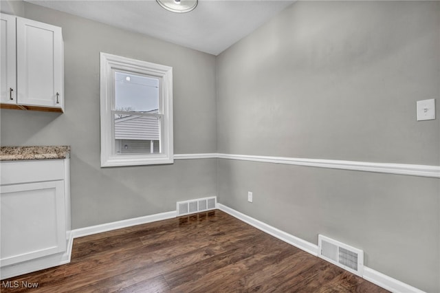 unfurnished dining area with dark hardwood / wood-style floors