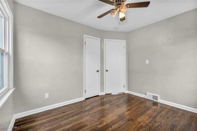 unfurnished bedroom with dark hardwood / wood-style floors and ceiling fan