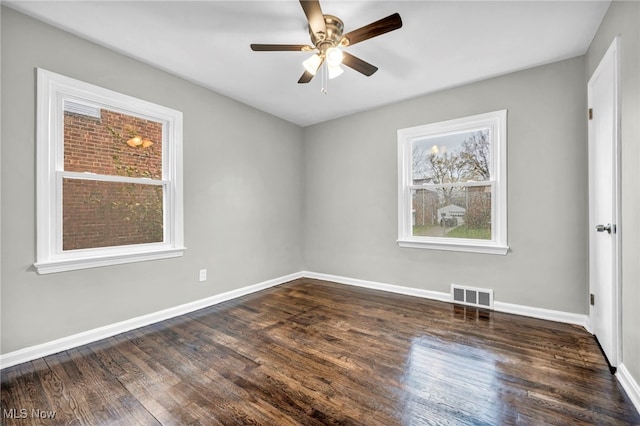 spare room with ceiling fan and dark wood-type flooring