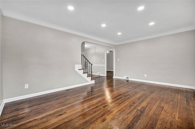 spare room with crown molding and dark hardwood / wood-style flooring