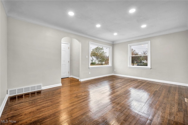 unfurnished room featuring dark hardwood / wood-style floors and ornamental molding