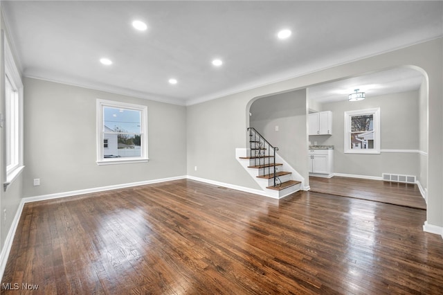 empty room featuring dark hardwood / wood-style flooring and crown molding