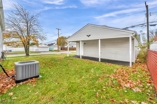 garage with a yard and cooling unit