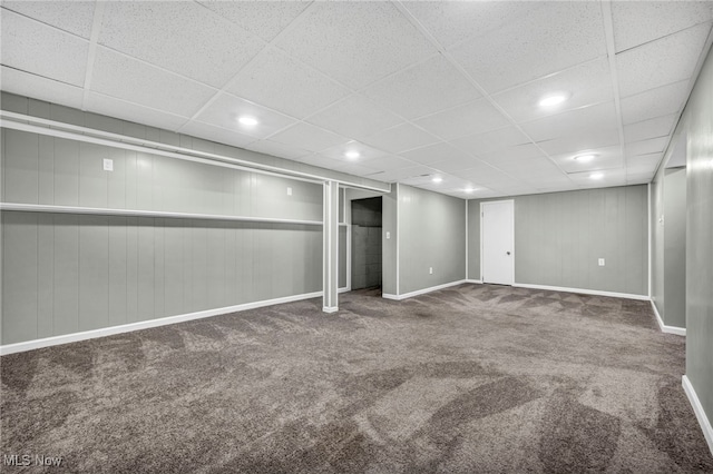 basement featuring carpet and a paneled ceiling