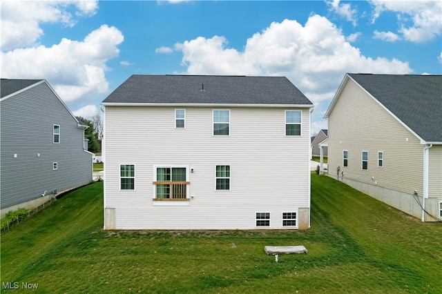 rear view of property with a yard