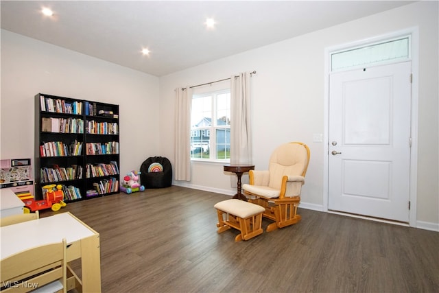 sitting room with dark hardwood / wood-style flooring