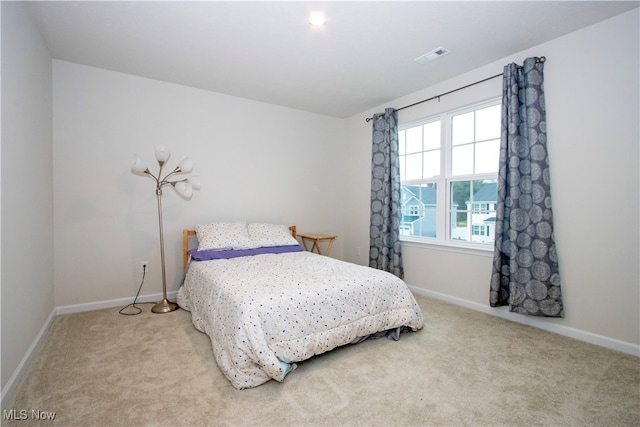 bedroom featuring light colored carpet