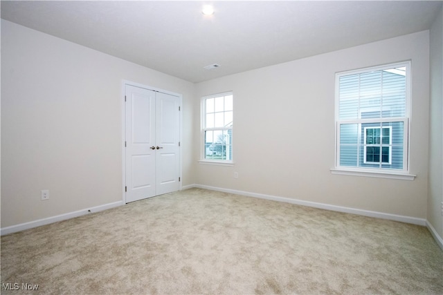 carpeted spare room with plenty of natural light