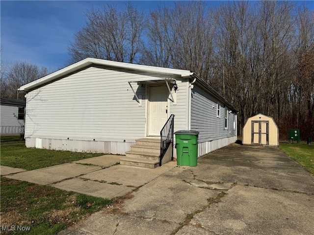 view of side of home with a shed