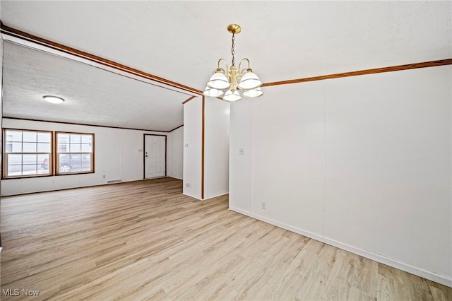 unfurnished dining area featuring vaulted ceiling, crown molding, a textured ceiling, an inviting chandelier, and light hardwood / wood-style flooring