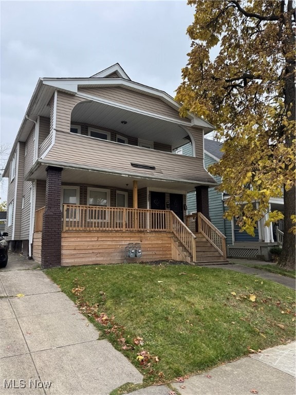 view of front facade with a front lawn and covered porch