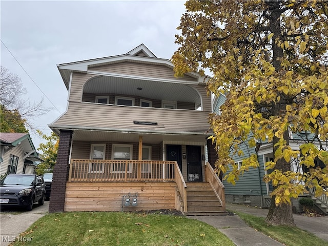 view of front of home featuring a balcony and covered porch