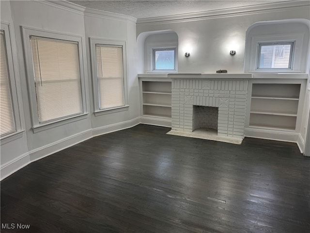 unfurnished living room with a textured ceiling, dark hardwood / wood-style flooring, ornamental molding, and a fireplace