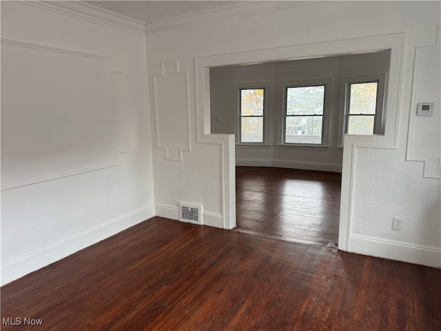 unfurnished room with dark hardwood / wood-style floors and crown molding