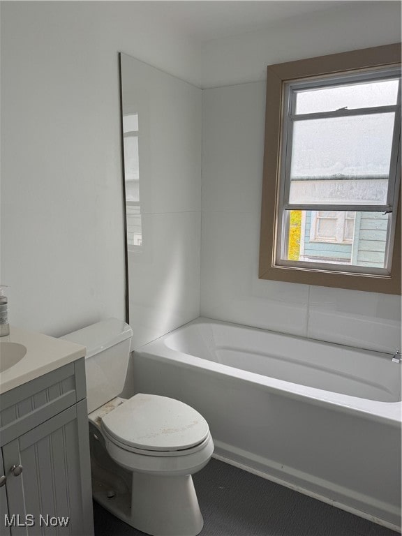 full bathroom with bathing tub / shower combination, vanity, and toilet