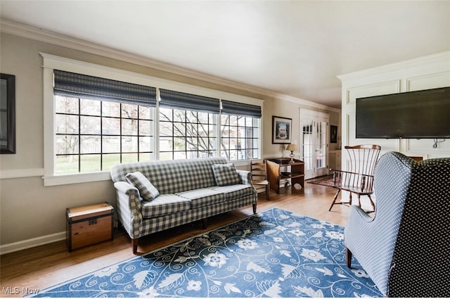 living room with hardwood / wood-style floors and ornamental molding