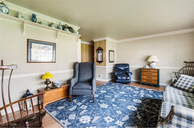 sitting room featuring wood-type flooring and ornamental molding