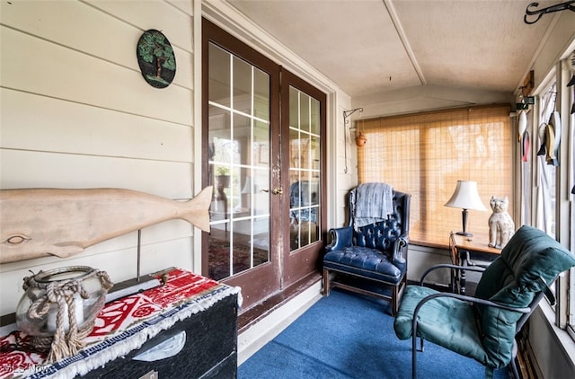 sunroom / solarium featuring french doors, vaulted ceiling, and plenty of natural light