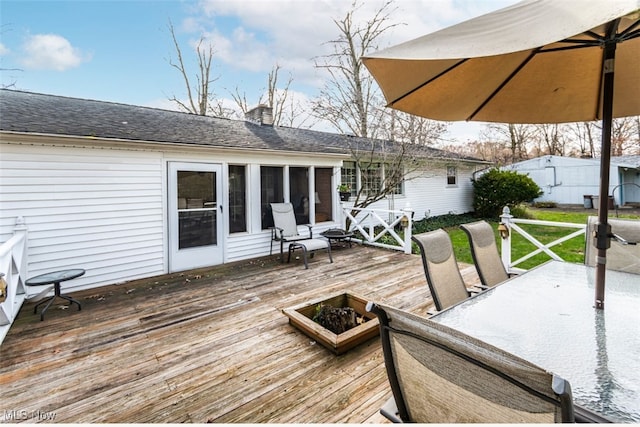 wooden deck with a sunroom