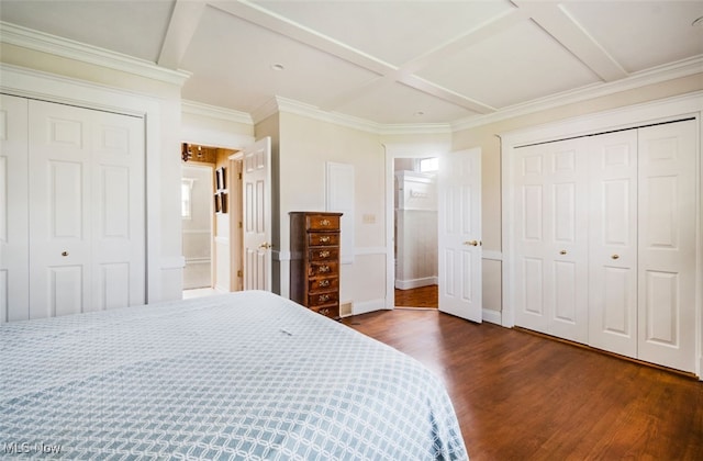 bedroom featuring ensuite bathroom, crown molding, dark wood-type flooring, and coffered ceiling