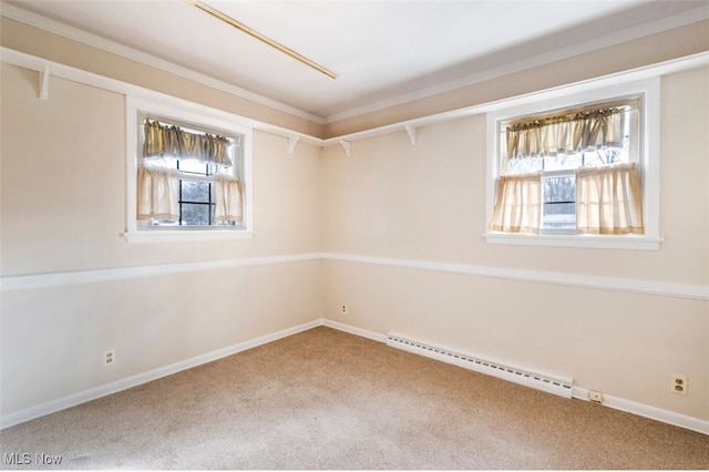 empty room featuring carpet floors, a healthy amount of sunlight, and a baseboard heating unit