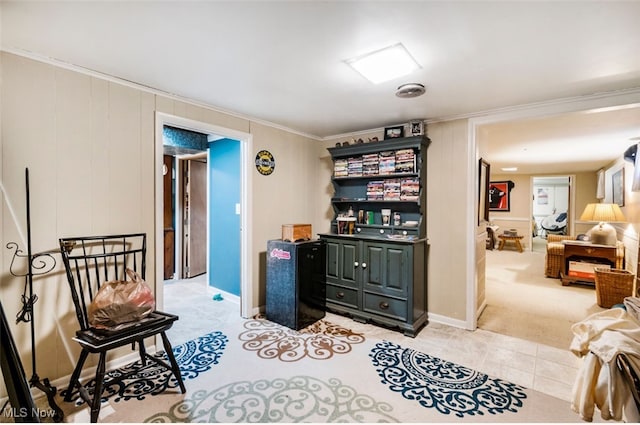 sitting room featuring light carpet and ornamental molding