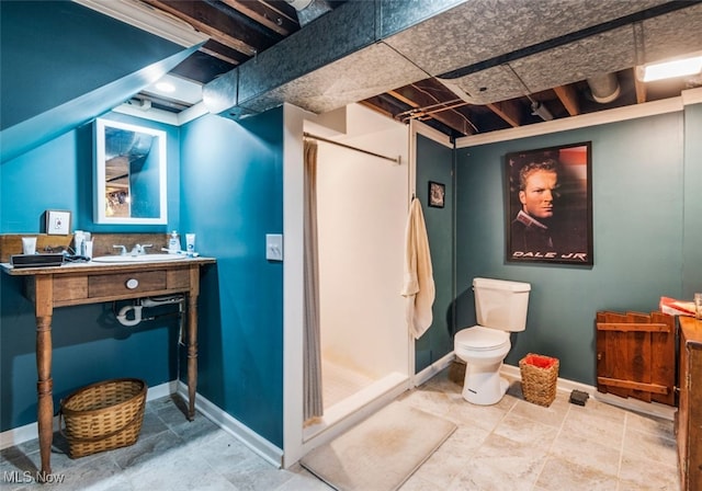 bathroom featuring toilet, a shower, and vanity