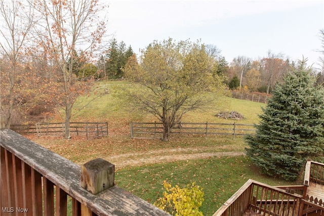 view of yard with a rural view and a deck