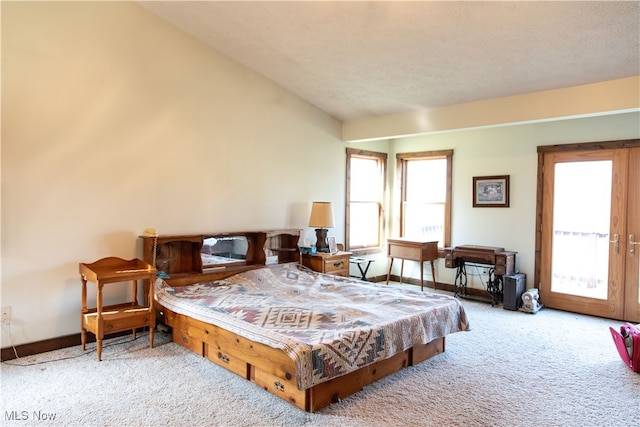 bedroom featuring light colored carpet, a textured ceiling, and vaulted ceiling