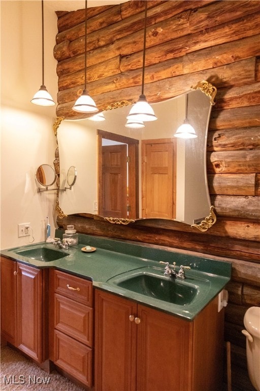 interior space with sink, rustic walls, and hanging light fixtures