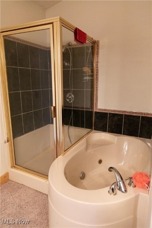 bathroom with a shower with door