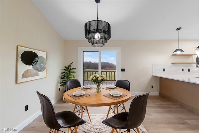 dining area with a chandelier and light wood-type flooring