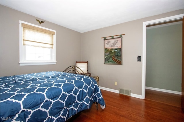 bedroom with a closet and dark wood-type flooring