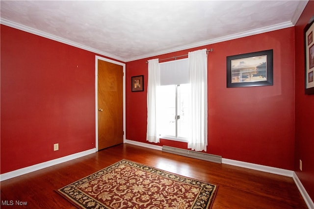 empty room featuring hardwood / wood-style flooring and crown molding