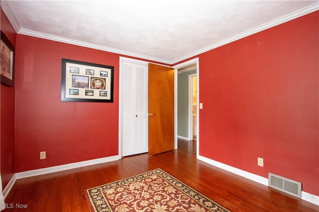 unfurnished room with wood-type flooring and crown molding