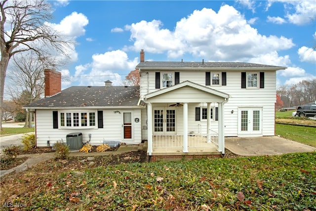 rear view of property featuring ceiling fan, a yard, french doors, central AC, and a patio