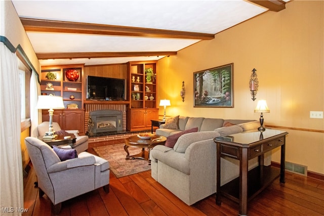 living room featuring lofted ceiling with beams, dark hardwood / wood-style flooring, and a fireplace